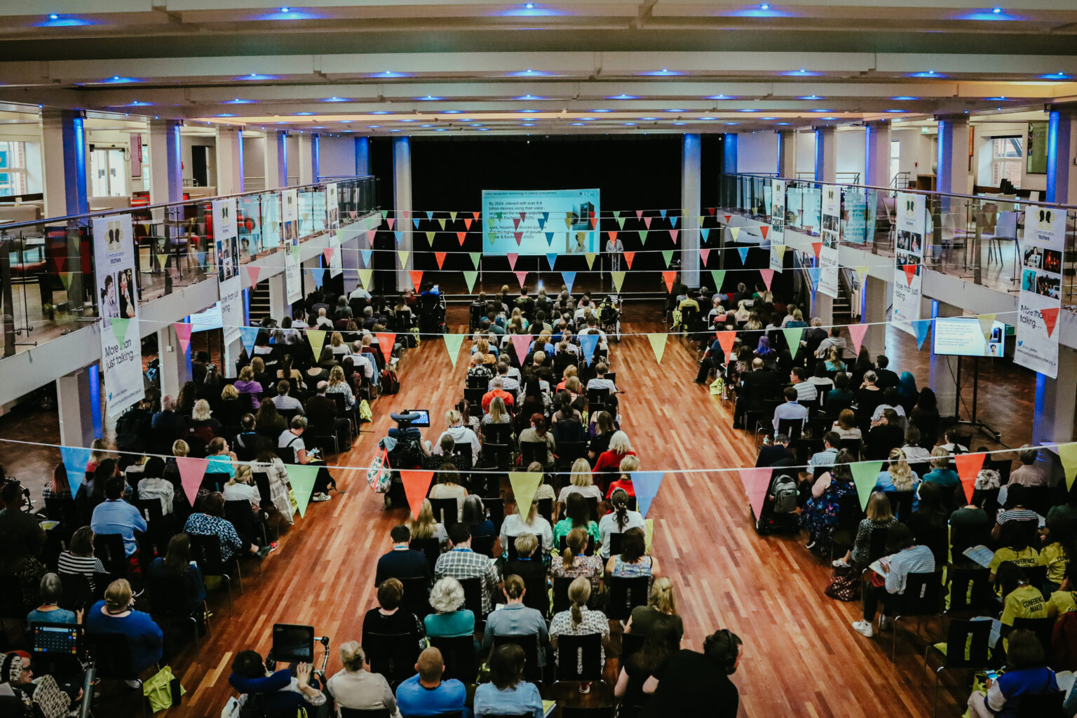 Conference attendees in a large hall.